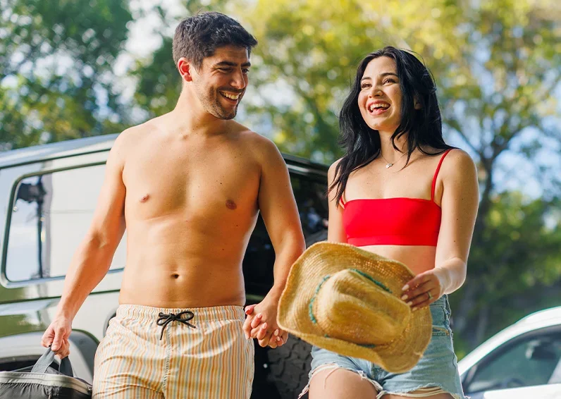 Smiling man looking to his left wearing a white tank top