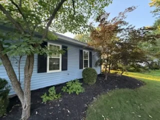 Painted house siding and landscaped front yard