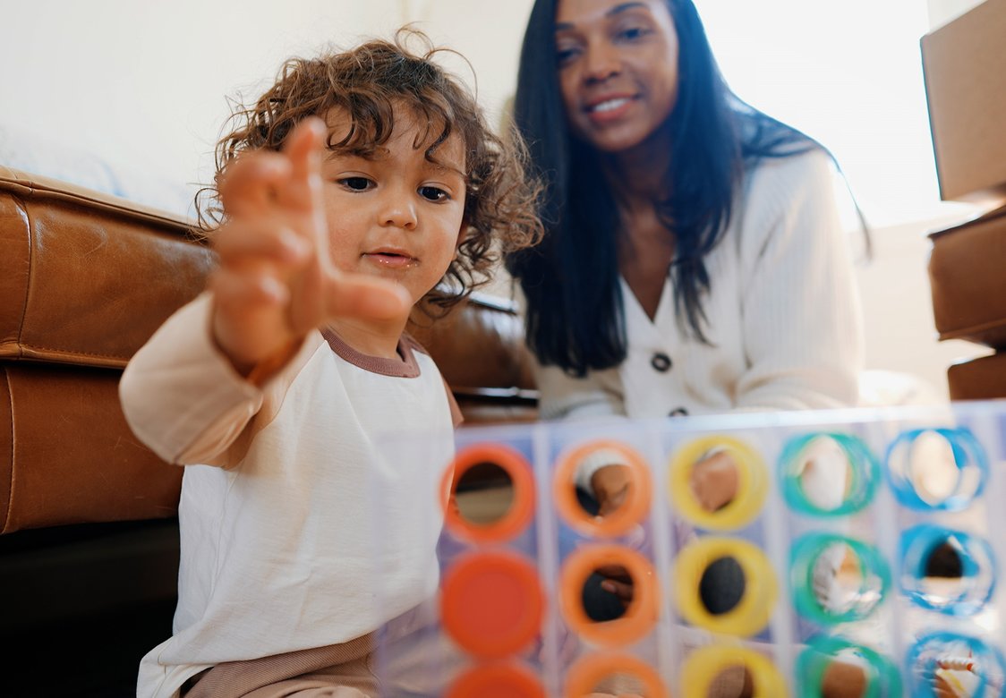 Mother and son playing with Lovevery toy