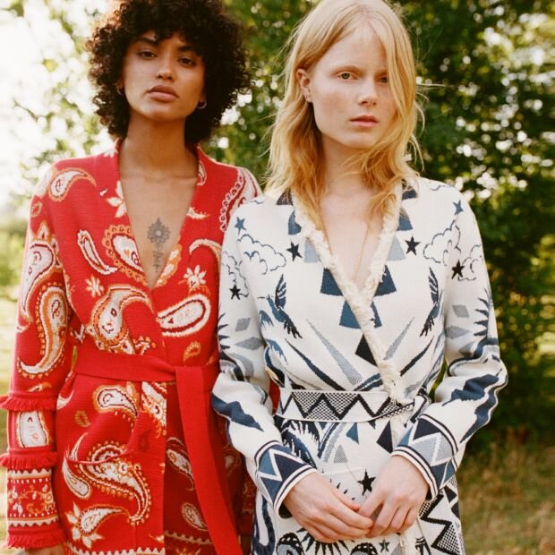 Two models wearing cotton jacquard belted cardigans with a paisley print, one in red & white and one in white & blue.
