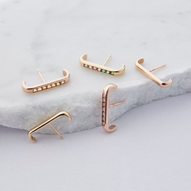 Three pairs of gem-embellished rose gold earrings.