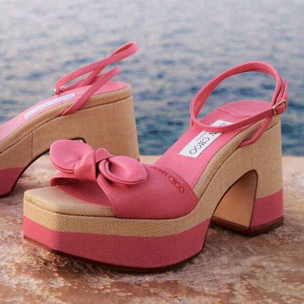 A pink and beige leather platform wedge sandal featuring a knotted strap and square toe.