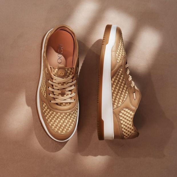 A pair of woven leather sneaker featuring a brown and beige neutral color scheme.