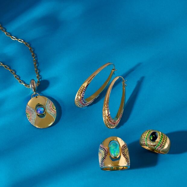 Jewelry pieces including ring, earrings, and a necklace. The pieces feature a gold body and turquoise gem embellishments.