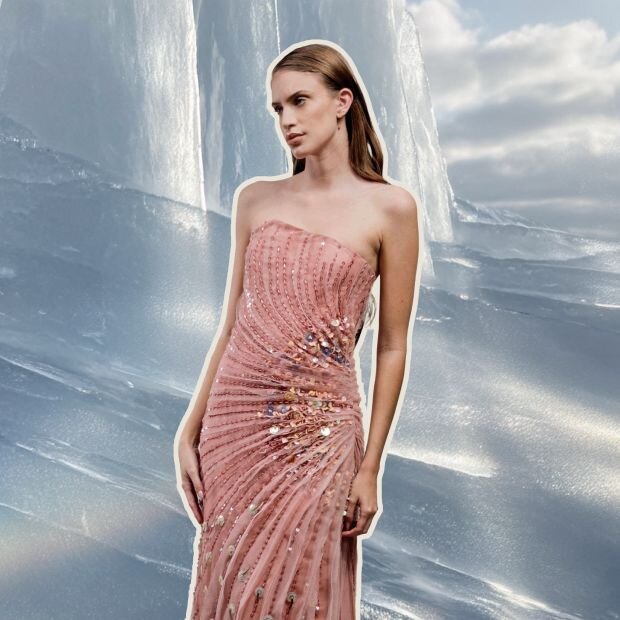 A yellow gold ring featuring a filigree brand and an emerald-cut diamond.