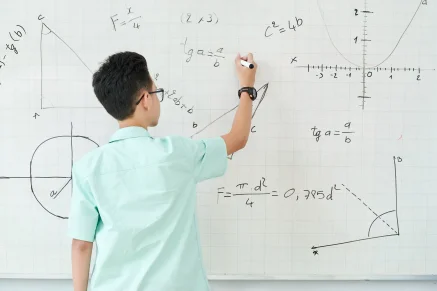 Student practicing geometry on the board