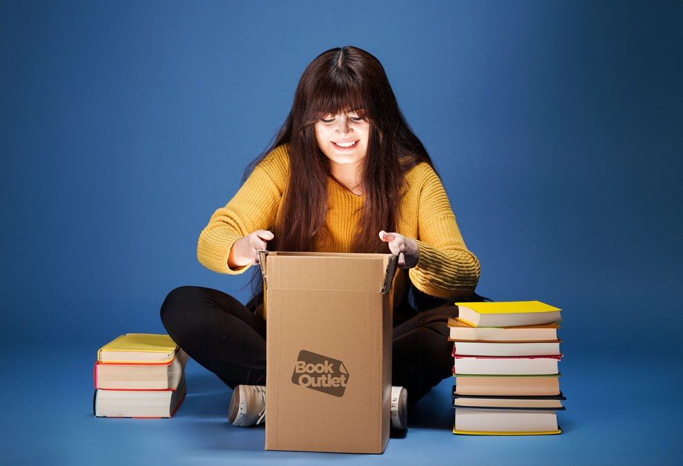woman smiling while opening a book outlet box 