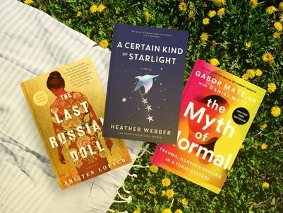 3 Books outside on the grass. The Myth of Normal: Trauma, Illness, and Healing in a Toxic Culture by Gabor Daniel Mate. The Last Russian Doll by Kristen Loesch. A Certain Kind of Starlight by Heather Webber