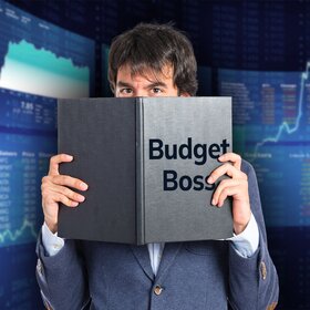 Man Holding Book in front of face entitled Budget Boss 