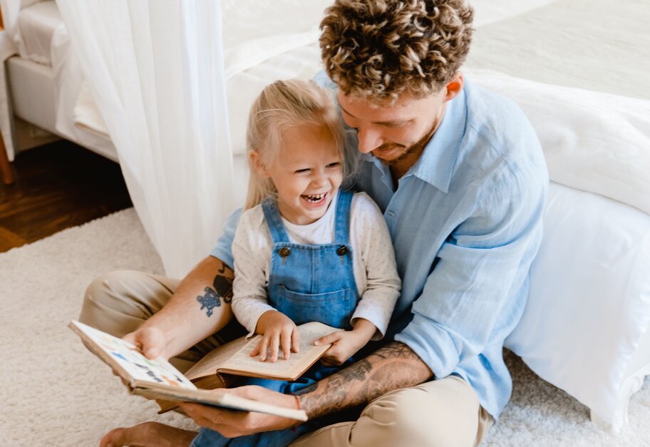 Father and Child reading and laughing together