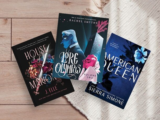 3 books laying out. House of Marionne (Bk. 1) by Elle, J. Lore Olympus (Volume 2) by Rachel Smythe. American Queen (New Camelot, Bk. 1) by Seirra Simone