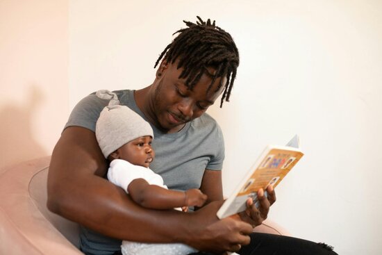 Father reading with infant child
