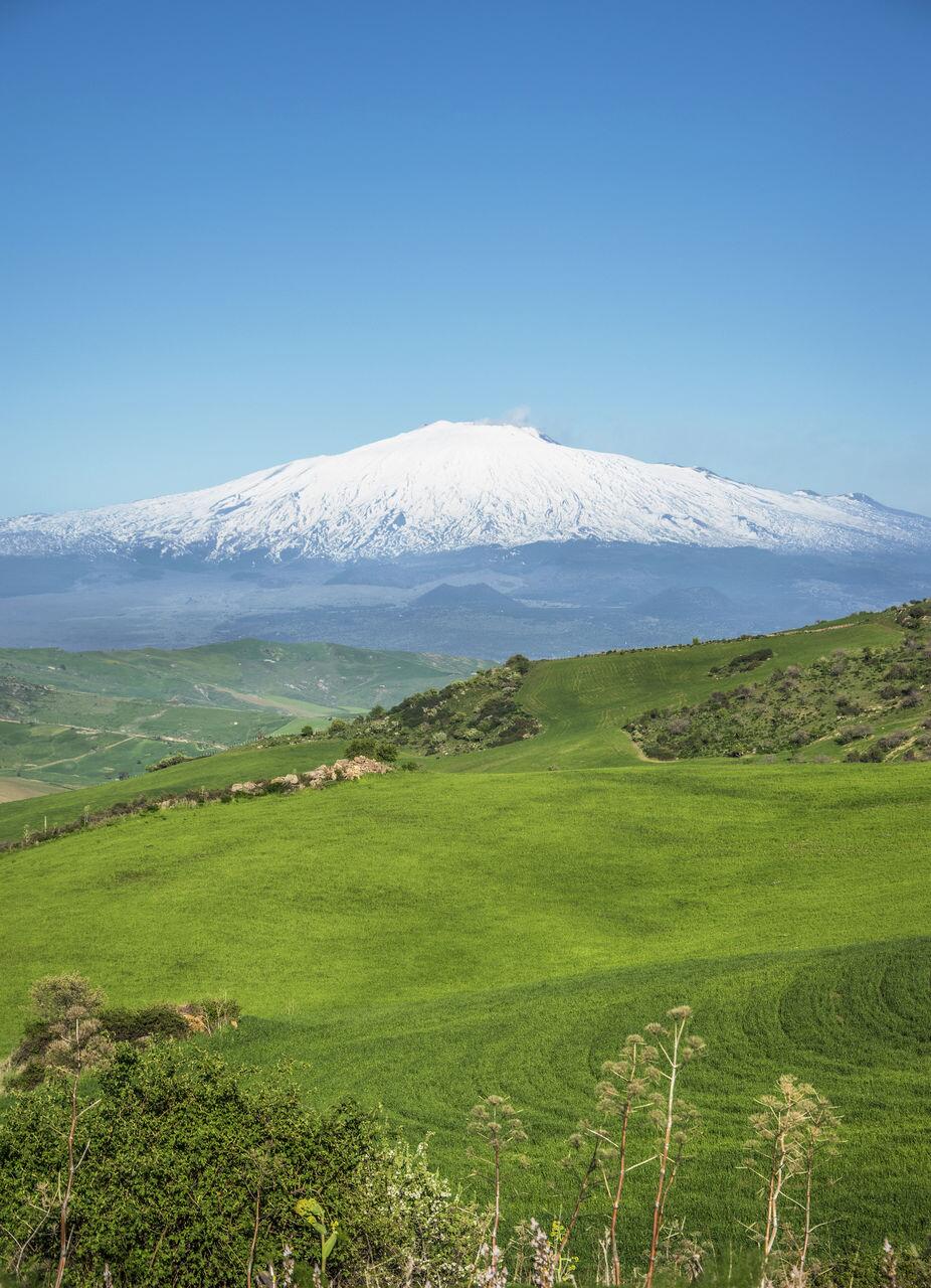Spring in Sicily with a snow-capped Etna rising majestically.
