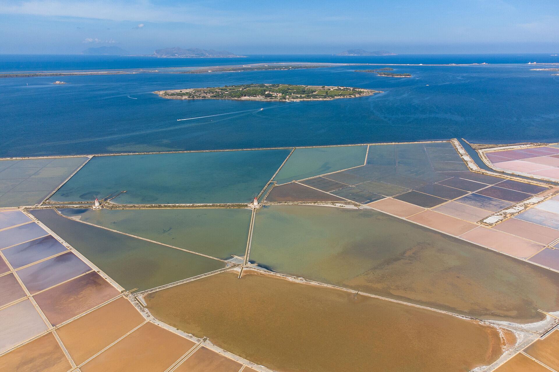 The islet of Mozia with the quilt of salt pans in the foreground.