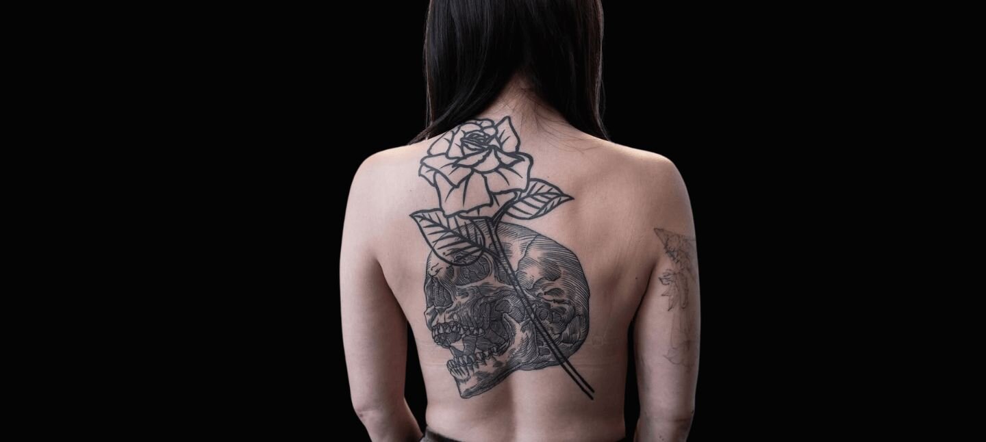Blackwork Skull and Rose Tattoo on Woman's Back