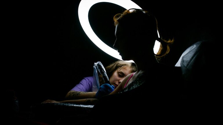 Tattoo Artist using laptop