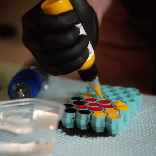 Jesse Smith Pouring Tattoo Ink into caps 