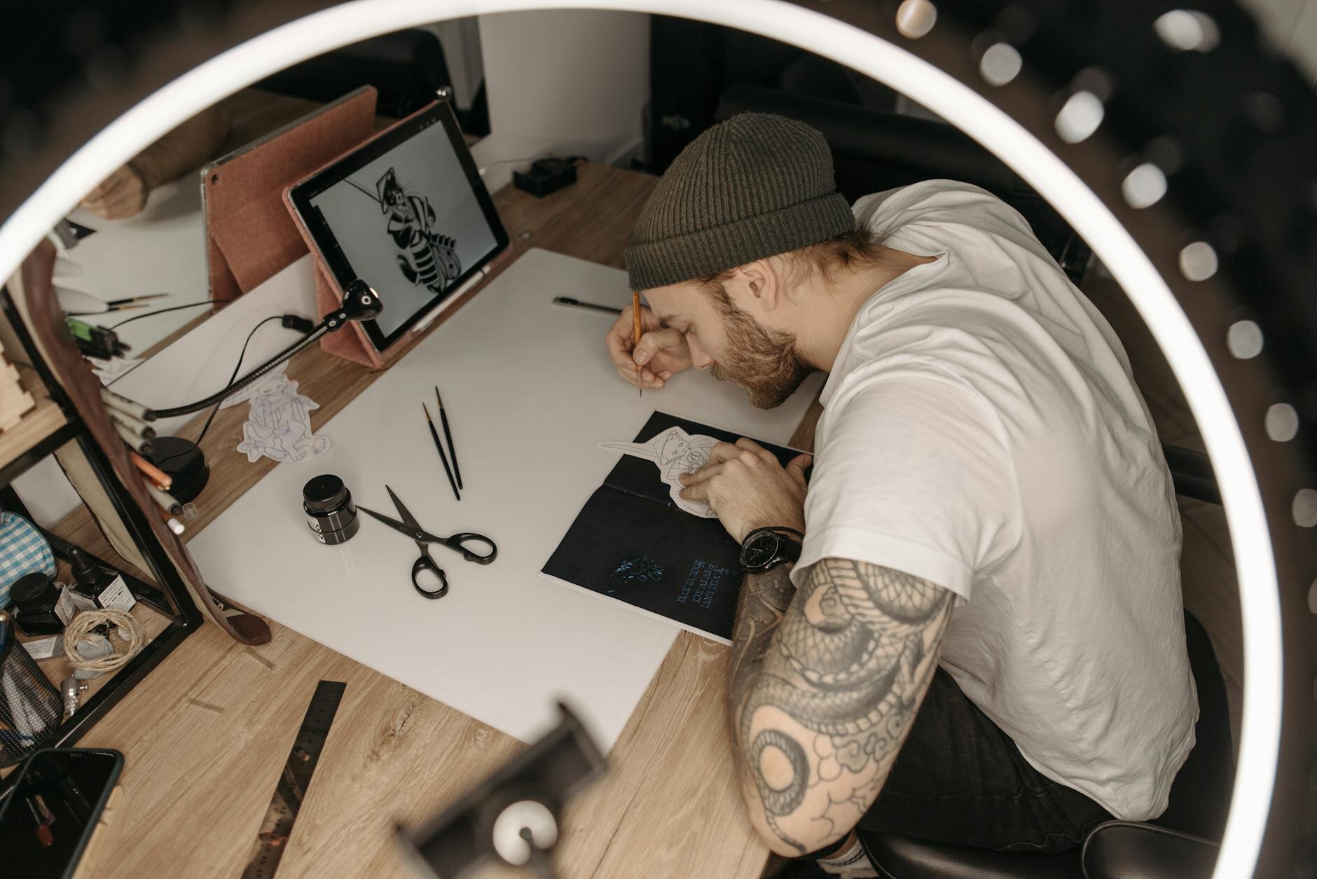 Tattoo Artist making a tattoo on a girls shoulder