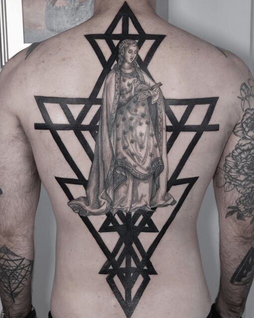 Black Work Tattoo Design of Woman and Symbol on Man's Back