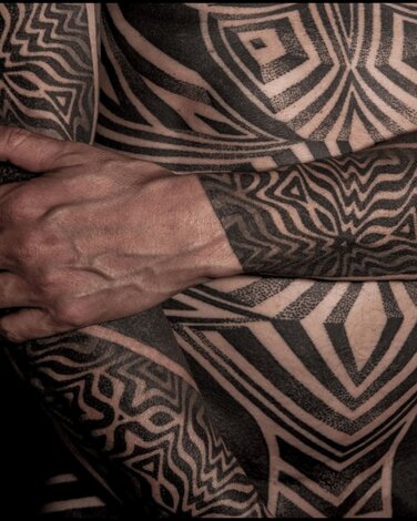 Black Symmetry Tattoo Design on chest and arms