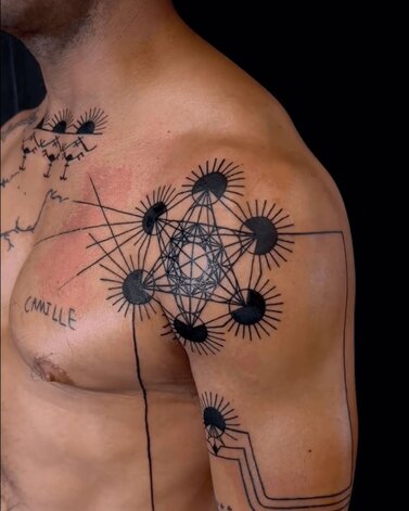 Danielle Nicole Geometric Tattoo on Man's Shoulder