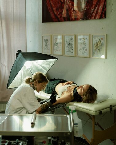 Woman getting a tattoo on her arm