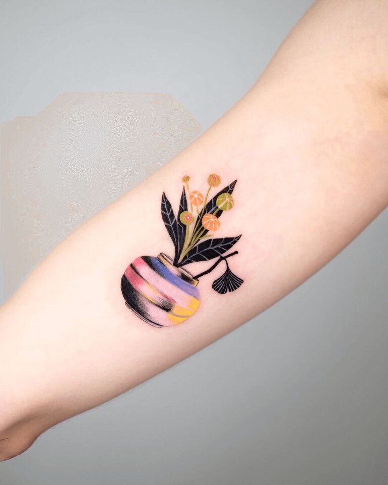Ari Tattoo Colorful flowers on forearm of girl
