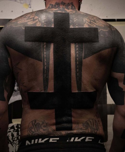 Blackwork tattoo design on mans back