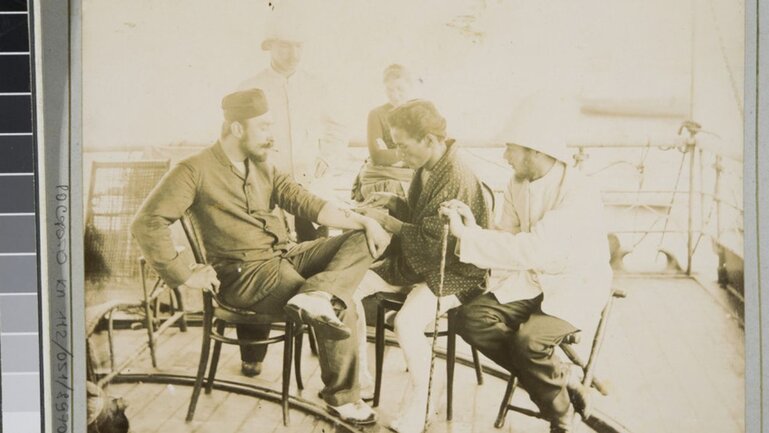 The Paskevich passenger getting his arm tattooed, in Nagasaki, Japan, 1889