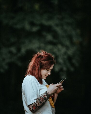 Tattoo Artist checking mobile