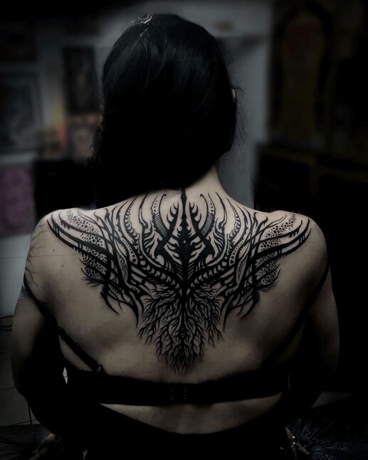 Jondix Blackwork Tattoo Design on woman's back