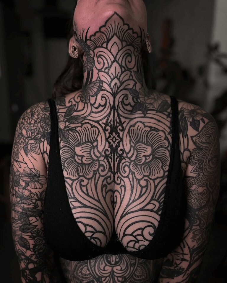 Alban Isaak Tattoo Designs on woman's Neck and Chest