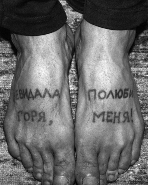 Tattooed symbols and letters on feet 