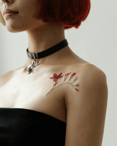 Girl with flower tattoo on her shoulder