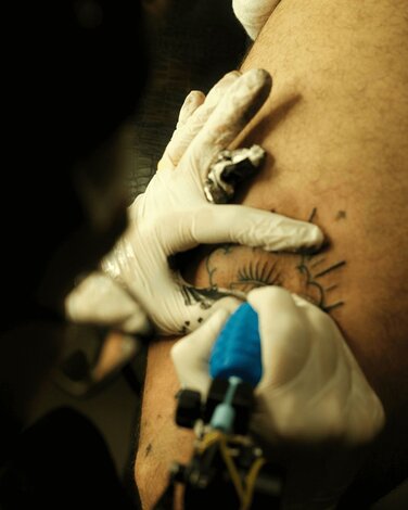 Tattoo artist making a tattoo