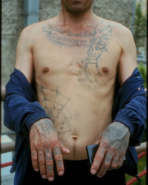 Man with tattoos on his chest and hands