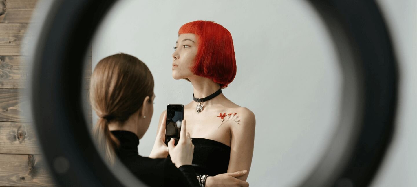 Tattoo Artist taking a photo of a tattoo on a client