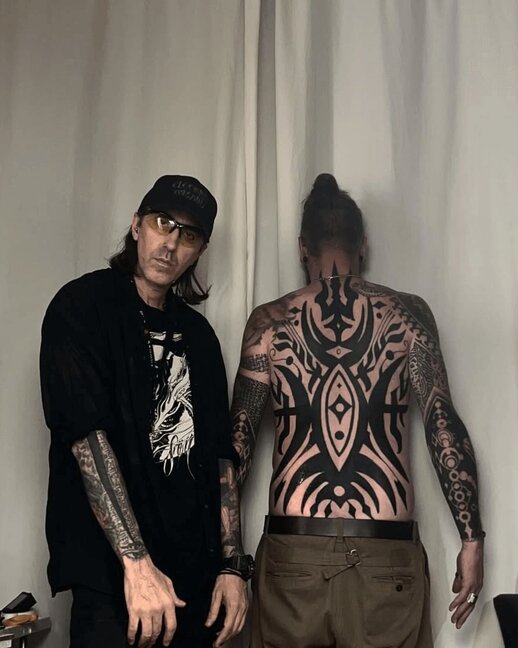 Jondix Tattoo Artist with Client