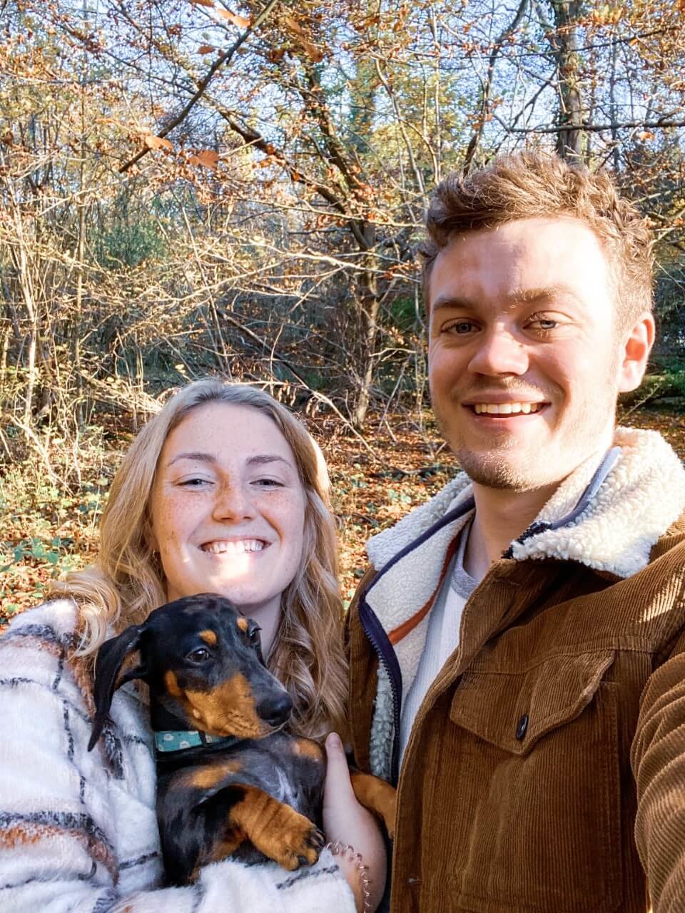 Charlie taking a selfie with Anna holding their dog Franklin