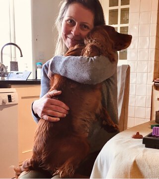 Alex holding her dog Crumble in her arms