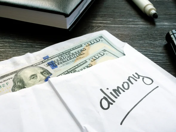 Open envelope with cash on the desk