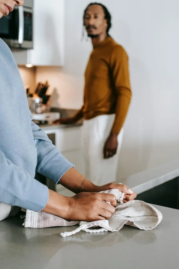 Couple in a tense kitchen moment, possibly planning a divorce.