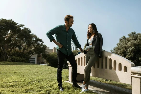 Couple in deep conversation outdoors, symbolizing post-divorce.