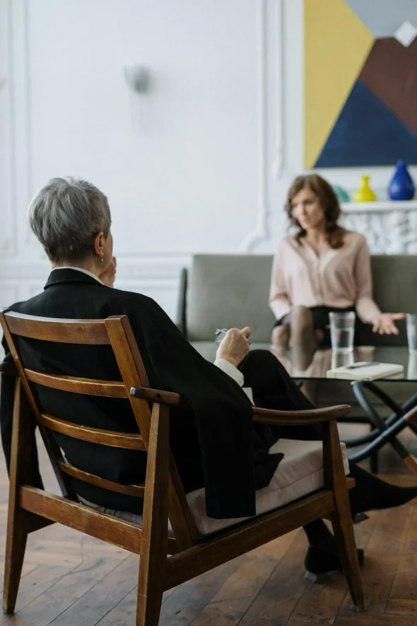 An attorney listening to a woman during a counseling session.