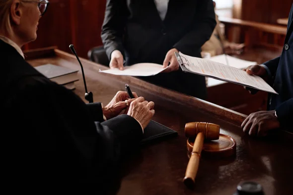 Close-up of both parties in a custody case facing a judge