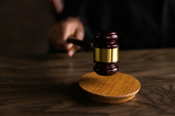 Judge's gavel on wooden table