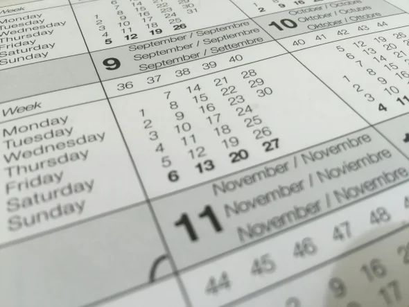 Close-up of a calendar displaying days and weeks, symbolizing the waiting period or timeline involved in legal processes such as divorce.