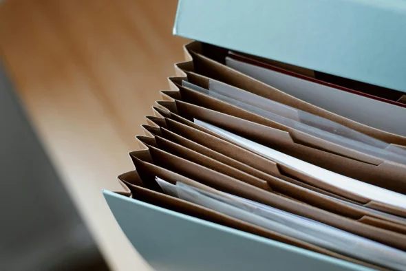 Accordion file folder with multiple organized documents inside, symbolizing legal paperwork and documentation, often used in cases like divorce filings or legal proceedings.