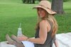 smiling woman in the park drinking true lemon