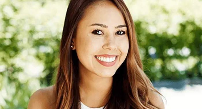 A headshot of a woman with brown hair smiling.
